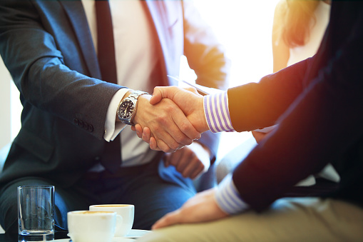 Business people shaking hands, finishing up a meeting Sane Manpower Services